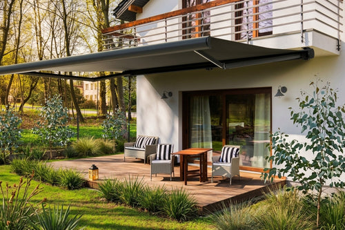 Retractable awning extended over a timber deck
